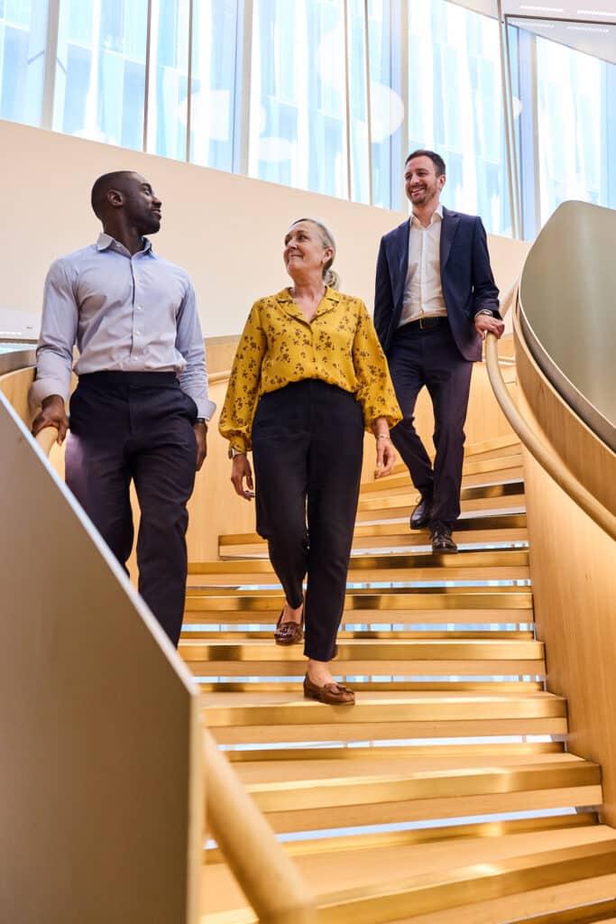 Advent colleagues walk down a staircase together